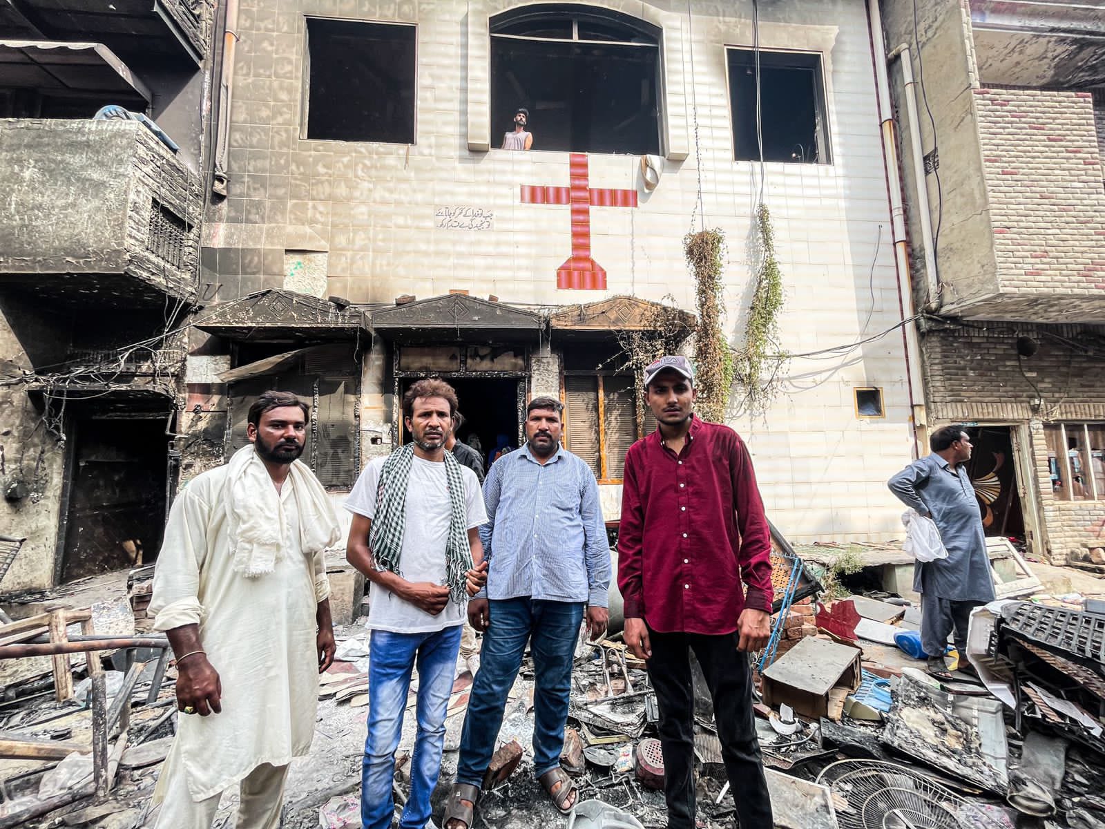 Sufyan with Operation LIFE outside a burned down church