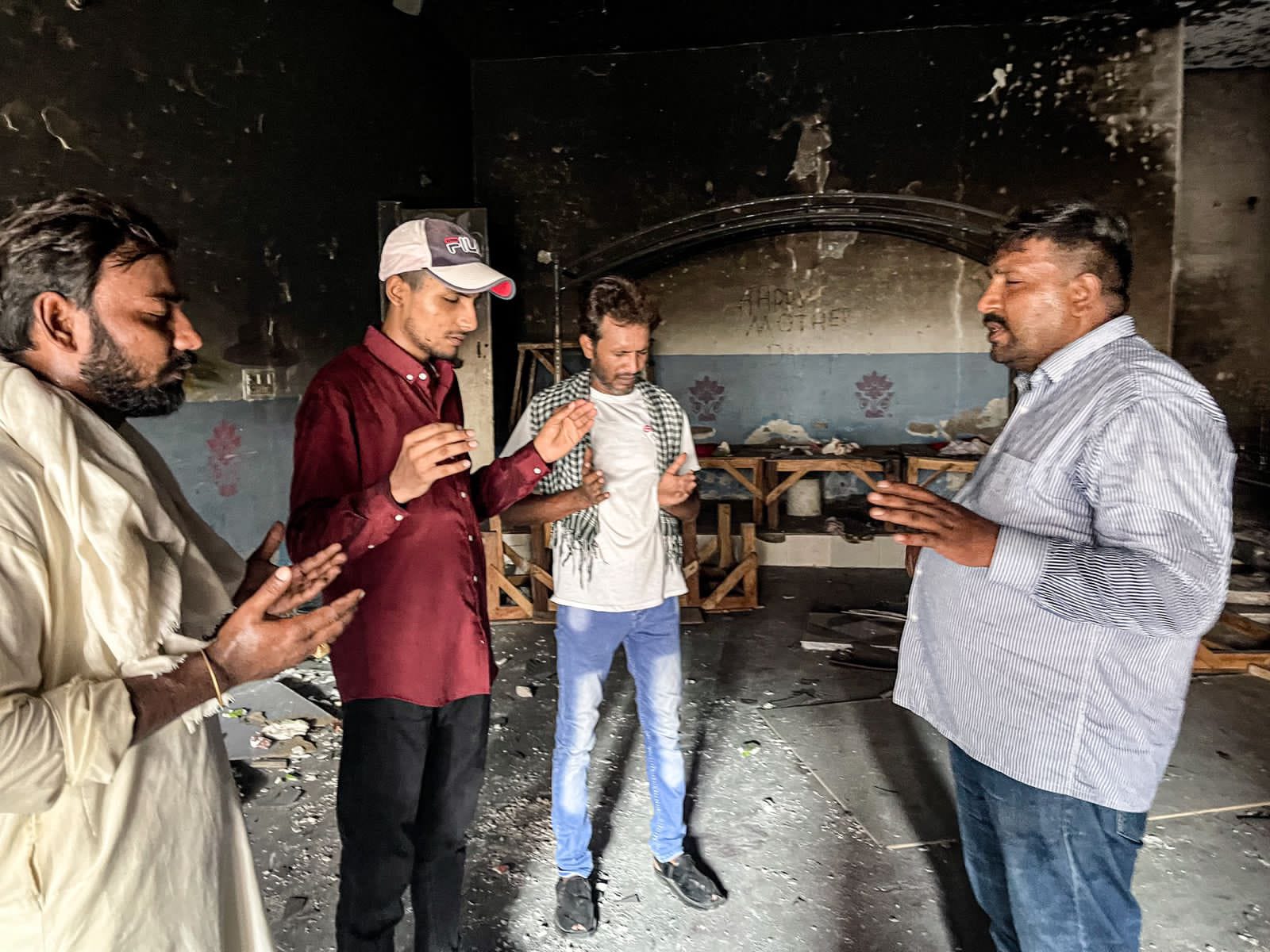 Sufyan and Local Pastors Praying Inside Burned Church