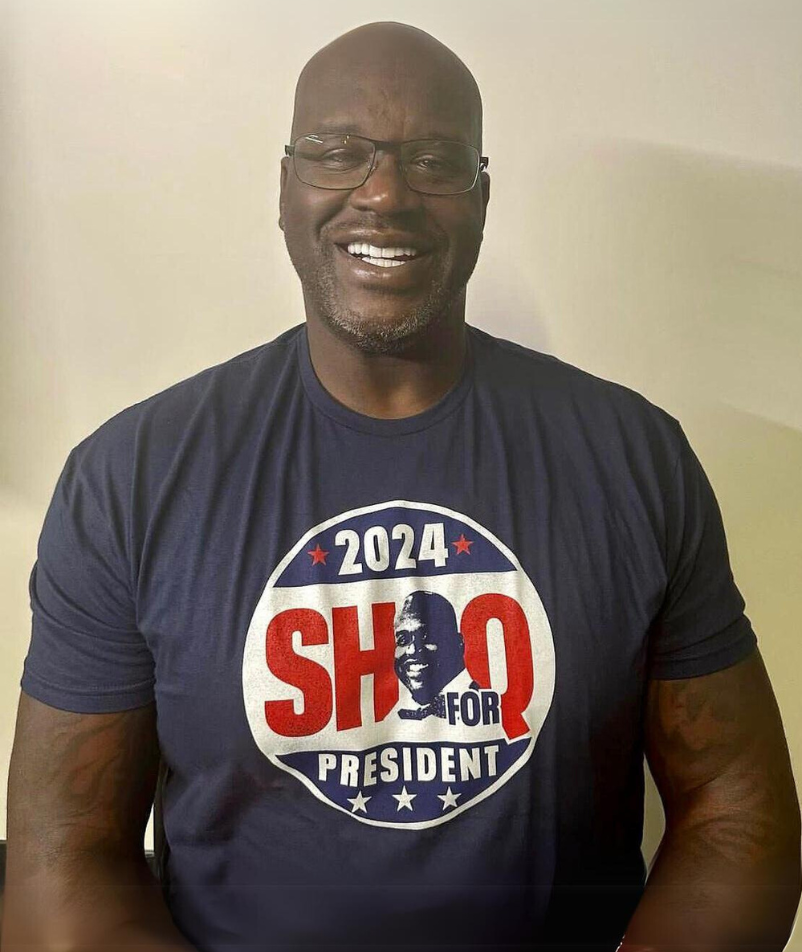 Dr. Shaquille O'Neal, Ed.D., wearing a "2024 SHAQ for President" shirt.