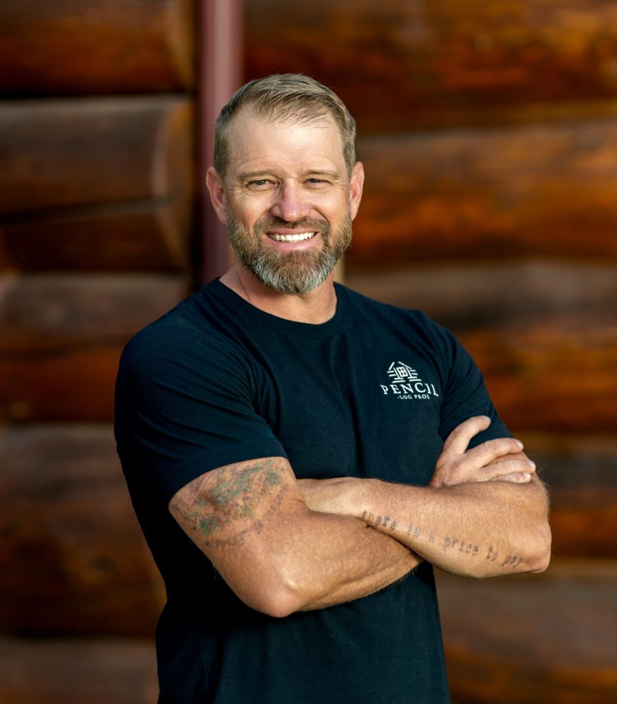 Brad Siler, founder of Pencil Log Pros, sitting confidently and representing his leadership in log home restoration and customer trust.