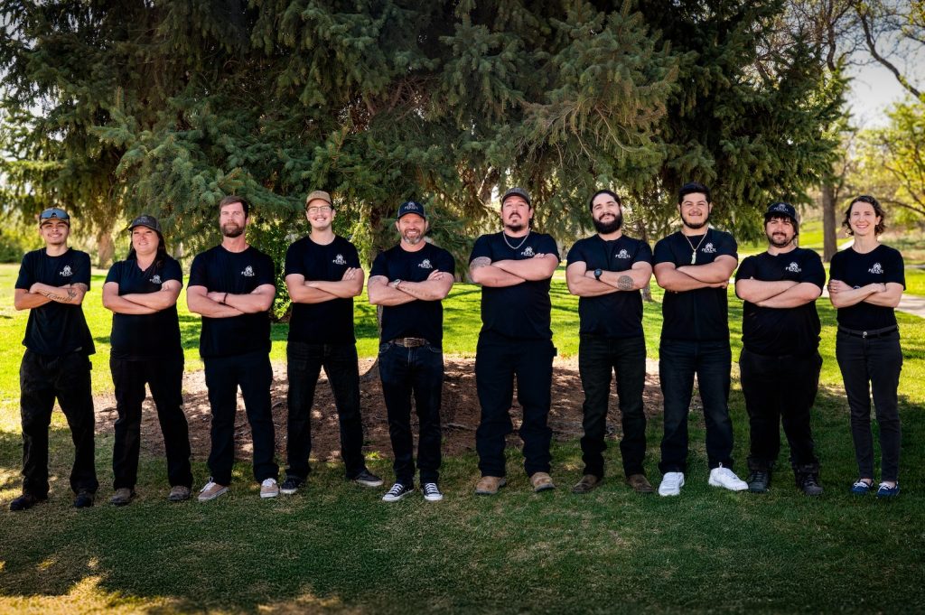 Pencil Log Pros team photo showing log home restoration experts in Colorado and Utah specializing in log cabin repair, staining, refinishing, sealing, media blasting, wood rot repair, and professional log home maintenance.