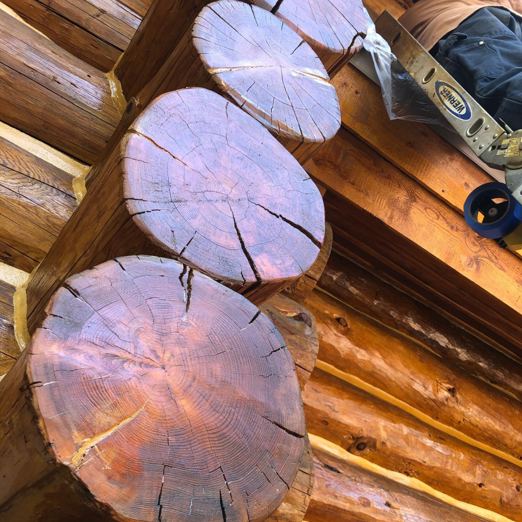 Log home professionally treated with stain and coatings by Pencil Log Pros, showing the superior alternative to paint for long-lasting restoration.